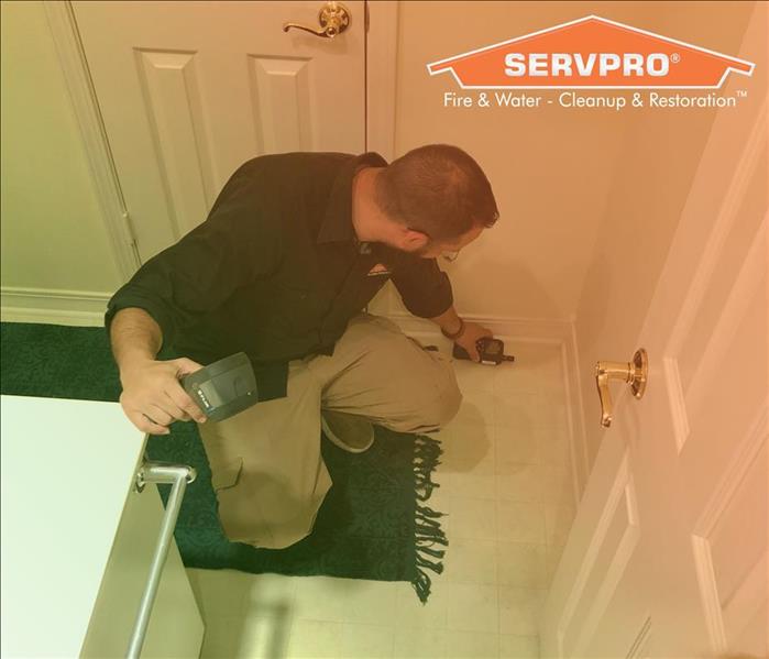 SERVPRO employee checking for moisture in indoor wall
