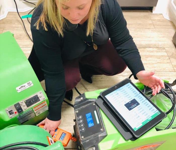 SERVPRO technician with monitoring equipment