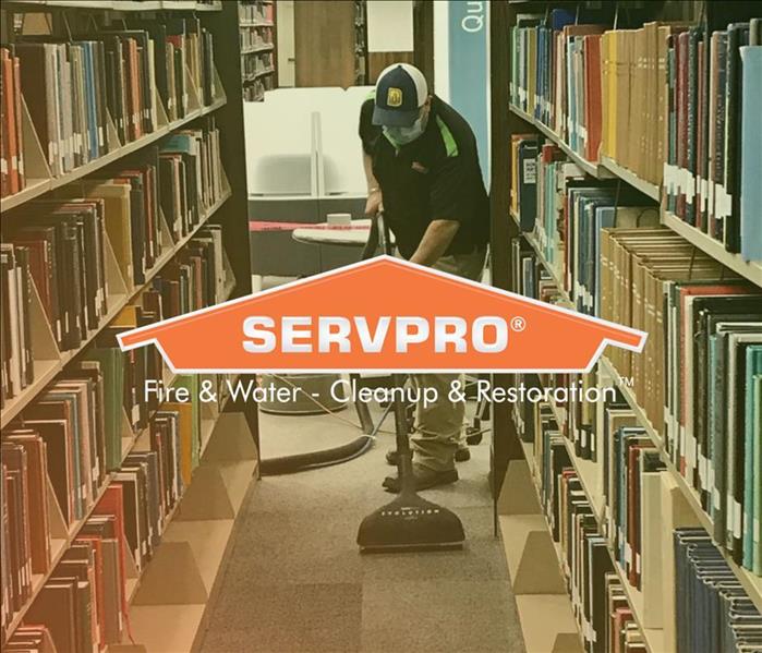 SERVPRO employee cleaning water damage in library