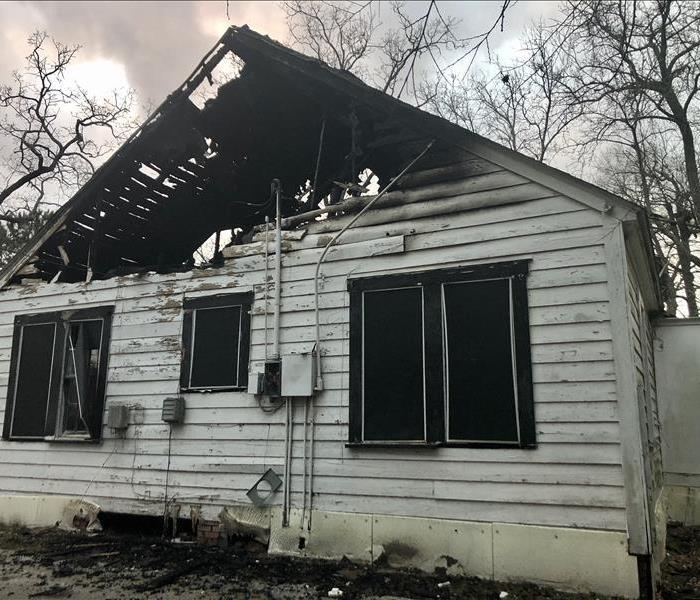 A home that has been burned and charred after a fire.