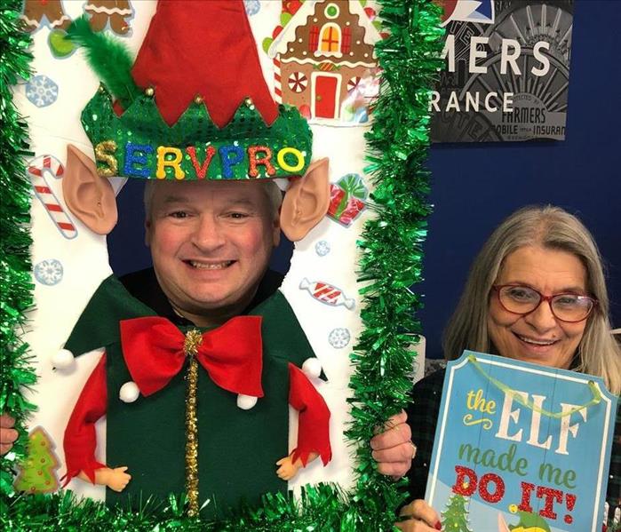 Locale Farmers Insurance Agents pose for pictures in this fun Elf themed Christmas frame!
